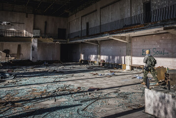 Tourist in Energetik Palace of Culture in Pripyat ghost city in Chernobyl Exclusion Zone, Ukraine