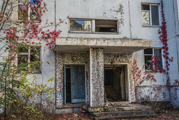 Fototapeta na wymiar Entrance to abandoned residential building in Pripyat ghost city in Chernobyl Exclusion Zone, Ukraine