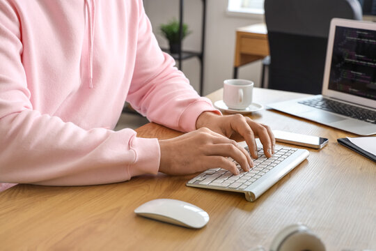 Male programmer working with computer in office, closeup
