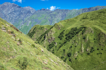 View from path from Stepantsminda town and Gergeti village to Gergeti Holy Trinity Church in Caucasus Mountains, Georgia. Mount Shani on left side