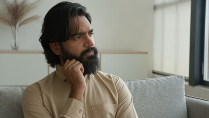 Thoughtful man Arabian muslim guy think idea indian male homeowner looking away dreaming thinking...