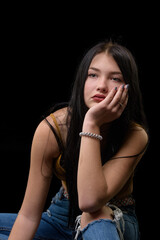 studio portrait of a young girl in torn jeans 1
