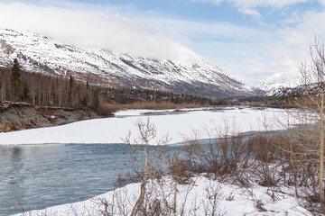 Tsaina River with snow capped mountains, Alaska, USA