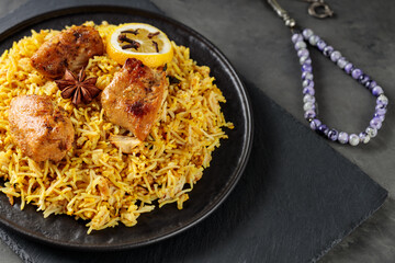 Chicken Biryani for Ramadan Iftar with basmati rice on Black Plate, Ramadan Food, Close-Up