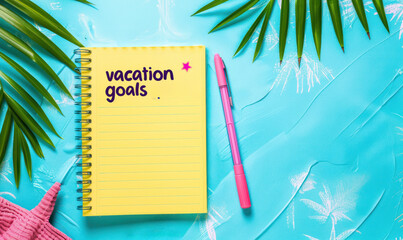 vacation goals written on a yellow notepad with a tropical background and pink pen, summer theme 