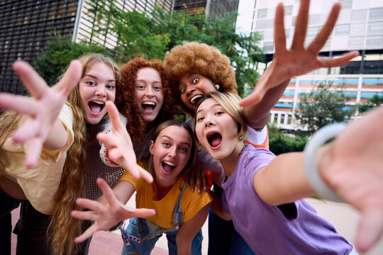 Female group of cheerful young girl students taking selfie portrait. Happy multiracial people looking at camera smiling. Concept of community, youth lifestyle and friendship. Confident Empowered women