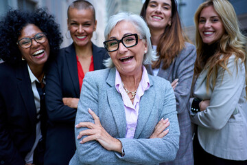 Portrait of smiling entrepreneurs in suits from an empowered happy women business in city. A group...
