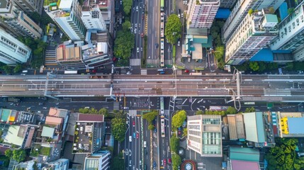 Naklejka premium Taipei's downtown aerial shot captures the intersection of cars and trains, illustrating the area's financial and smart urban tech districts