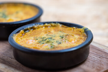 Scampi pan in curry sauce, Scampi baked in curry sauce, dish with shrimps on marble background, food photo