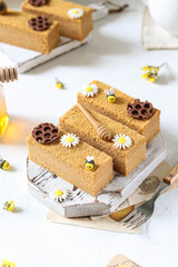 Honey cake with layers, decorated with bees and flowers.