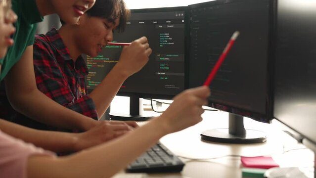 Slow motion back end software developer engineer for computer programming working together on debugging writing computing code, solving complex algorithms display on monitor in office. Burgeoning