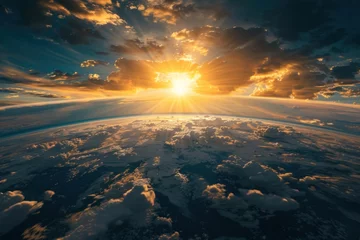 Photo sur Plexiglas Nasa The sun is shining through the clouds, creating a beautiful and serene atmosphere. The sky is filled with fluffy white clouds, and the sun is just beginning to rise