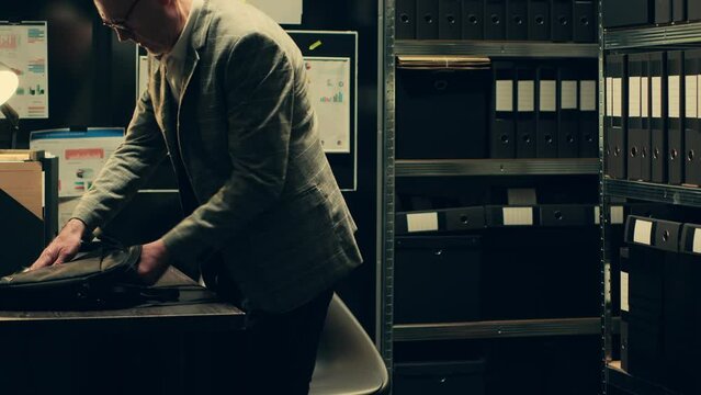 Private inspector opening laptop to cross examine forensic evidence, browsing through classified documents in police archive room. Consults media archives for additional information. Camera A.