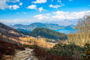 Fototapeta na wymiar Hikers on Scenic Trail with Rara Lake Panorama, Chuchemara Hills, Nepal