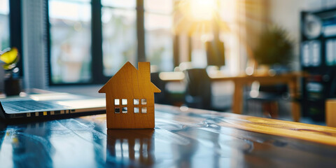 Miniature house on wooden table, office background, real estate concept