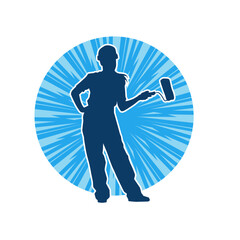 Silhouette of a female worker carrying painting tool. Silhouette of a woman painter worker in pose.