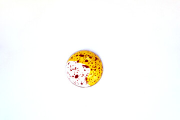 A piece of colored round delicious fancy chocolate on a white background