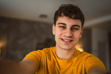 Obraz premium Portrait of young caucasian teen male young man stand at home