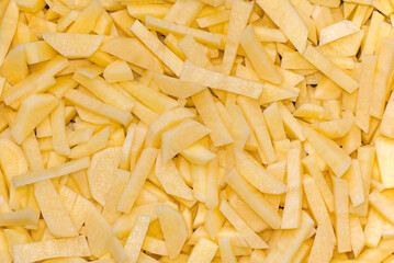 Yellow raw cut potatoes, preparation for dinner, close-up, food