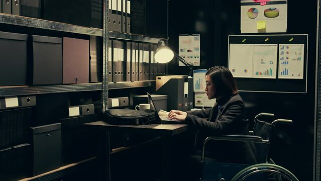 Forensic team conducting private investigation with case files, studying classified records in incident room. Woman wheelchair user collaborating with senior inspector at federal agency. Camera B.
