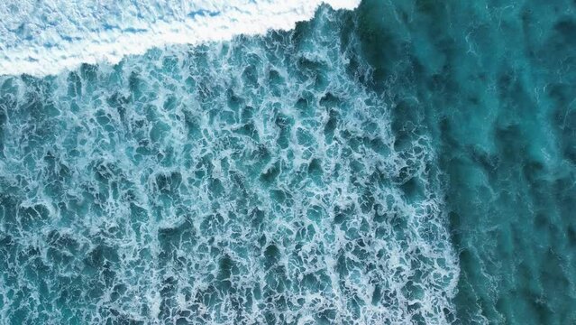 Beautiful texture of big power dark ocean waves with white wash. Aerial top view footage of fabulous sea tide on a stormy day. Drone filming breaking surf with foam in Caribbean Sea