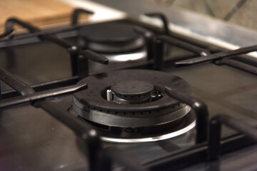 Metal home gas stove not working - empty burner, blurred background, selective focus, fuel...