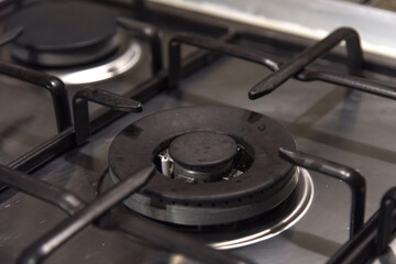 Metal home gas stove not working - empty burner, blurred background, selective focus, fuel...