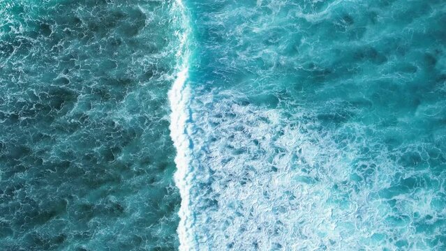 Beautiful texture of big power dark ocean waves with white wash. Aerial top view footage of fabulous sea tide on a stormy day. Drone filming breaking surf with foam in Caribbean Sea