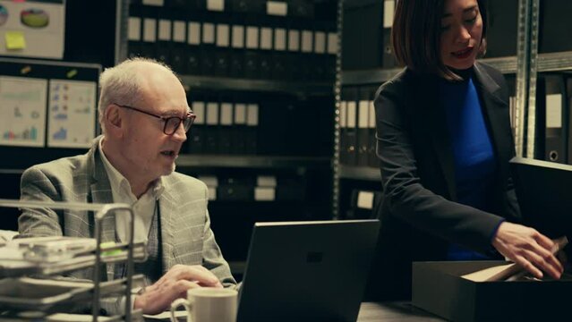 Forensic team examining classified documents and medical records, working on reenacting crime scene timeline to find suspect. Inspector and law agent conducting investigation. Camera B.