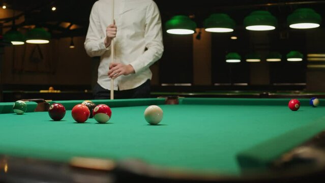 Young men playing American billiard poule close-up. Colorful balls on green billiards table .Billiard balls with numbers on a pool table. Billiards team sport.