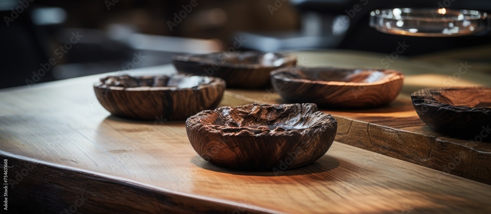 Poster a wooden table is neatly arranged with wooden bowls filled with various types of food. the bowls are