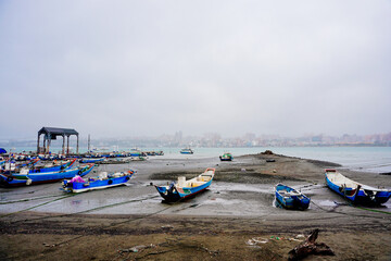 Bali, New Taipei, Taiwan, Republic of China, 01 22 2024: Cruise ferry boat and port on Clean Tamsui river in a raining day in winter