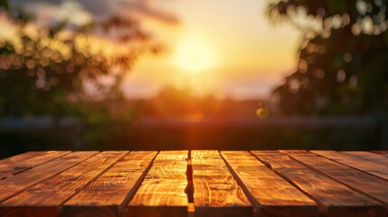 Naklejka na ściany i meble Wooden table top with copy space. Sunset background