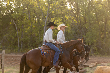 Father and Son cowboys riding