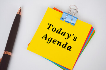 Today's agenda text on yellow notepad. Business meeting Agenda.