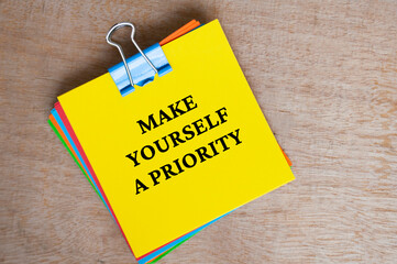 Make yourself a priority text on yellow notepad. Motivational concept.