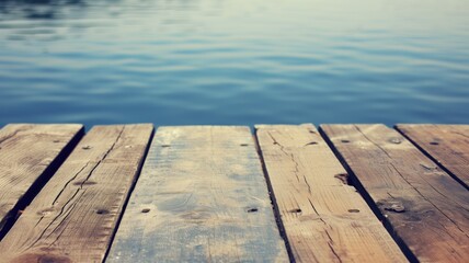 Wooden planks of a dock lead the eye to peaceful blue waters