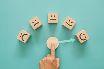 Service rating, satisfaction and positive feedback concept. A man choose wooden cube with smile...