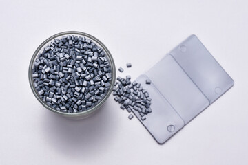 pearl silver masterbatch granules on a white background, equipped with a color chip as an example...