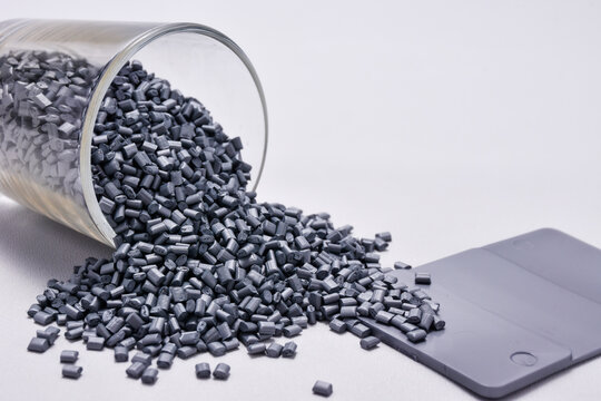 pearl silver masterbatch granules on a white background, equipped with a color chip as an example of the color produced, this polymer is a coloring product for products in the plastics industry