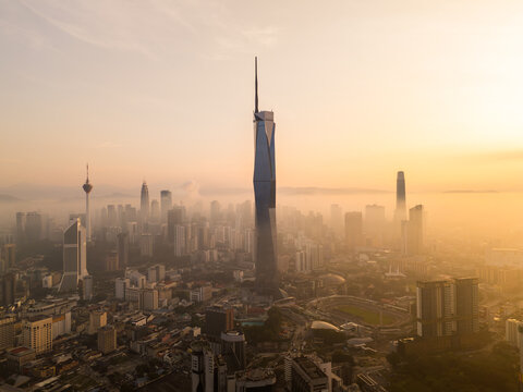 Aerial golden sunrise at Kuala Lumpur city skyline.