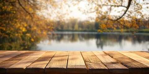 Rustic wooden tabletop overlooking a serene autumnal lake scene, with the warm golden hues of fall trees reflected in the calm water.