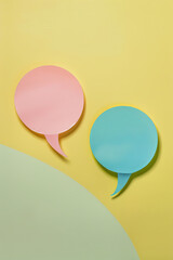 Two blank conversation bubbles on colorful background