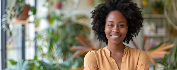 Smiling afro woman standing with her arms crossed, looking at camera.