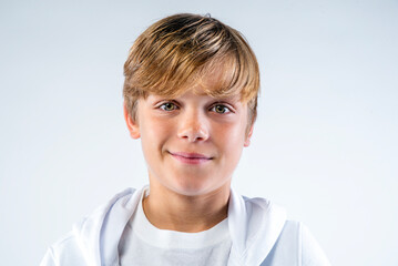 Close up portrait of a smiling preteen boy dressed in white