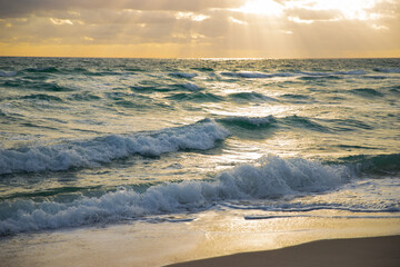 Amazing sunrise horizon, golden sky, turquoise sea waves