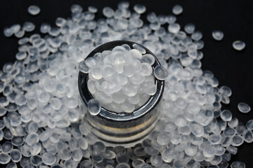 Virgin polypropylene (PP) granules on a black background, this polymer is one of the main materials...