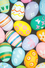Collection of colorful easter eggs on green grass to celebrate Easter or spring.