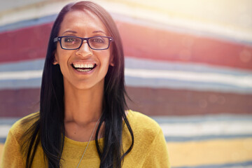 Woman, portrait and smile for eyewear outdoors, cool frame and proud of lens by wall background....