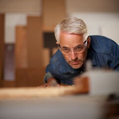 Male carpenter, thinking and planning in workshop, safety and glasses in small business. Design,...